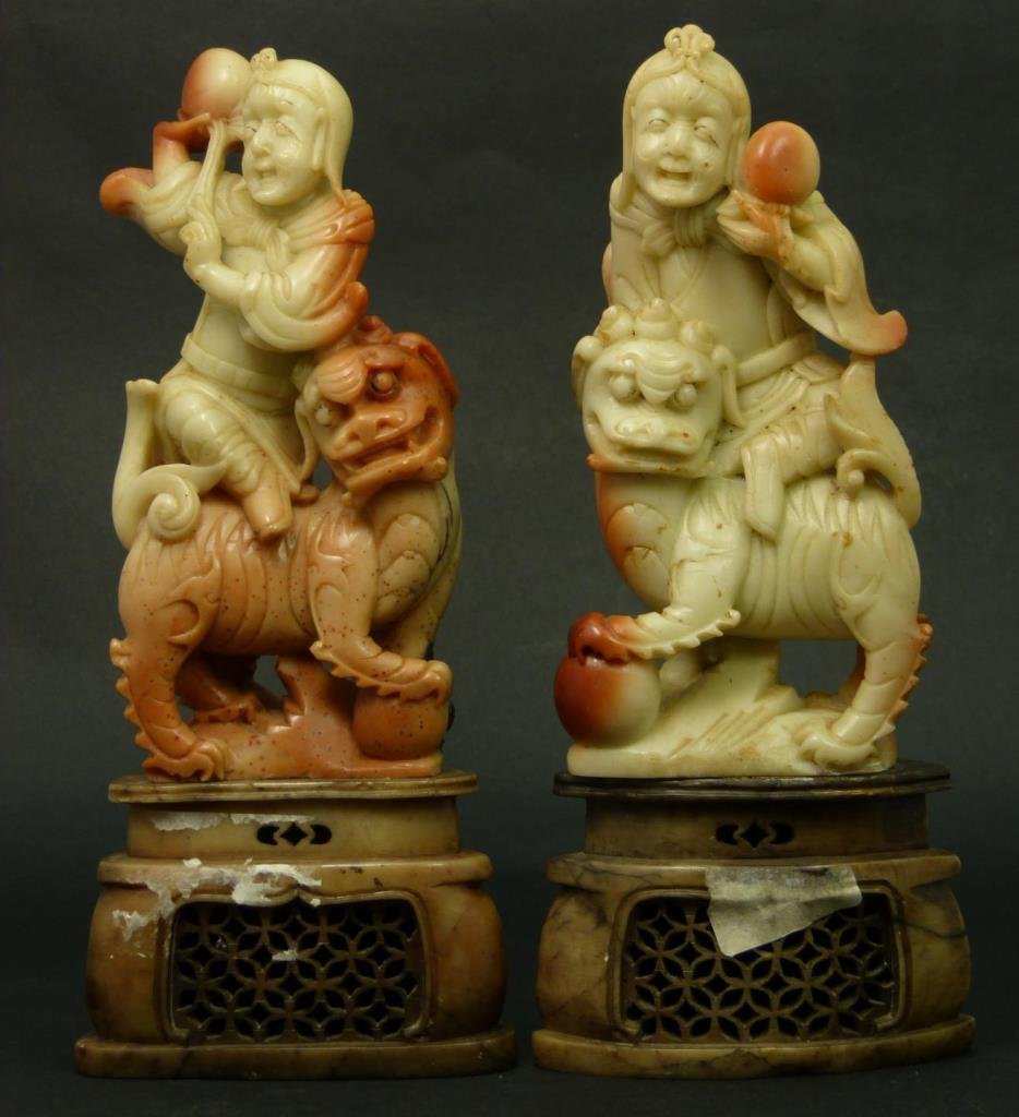 WONDERFUL 19TH CENTURY CHINESE SOAPSTONE CARVINGS: A pair of very nice soapstone sculptures depicting Quan Yin seated on foo lions; each holding peach. Soapstone having an attractive tan to iron red Shoushan tone. Sits on fitted soapstone base. Circa 