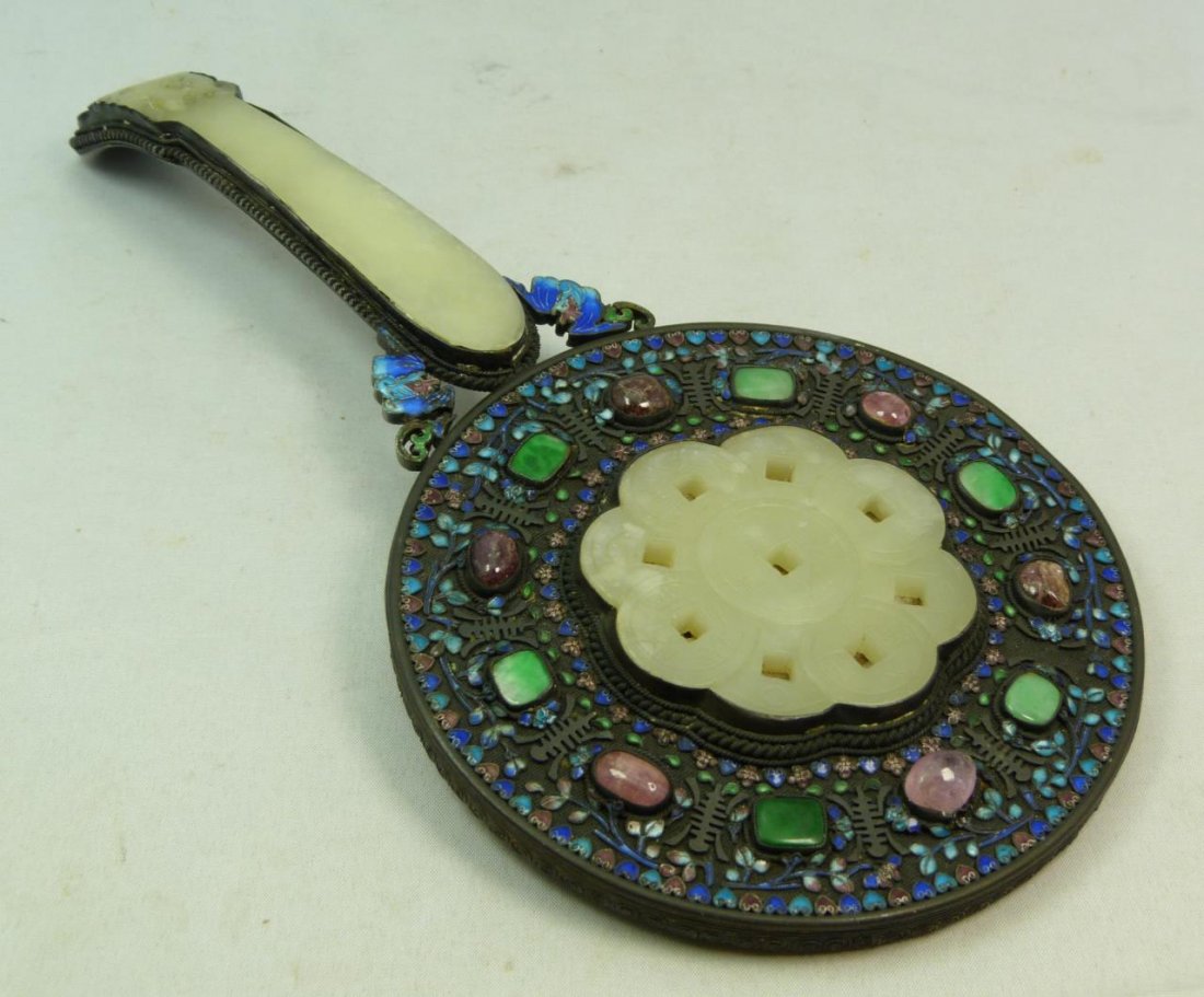 ANTIQUE CHINESE FILIGREE SILVER WHITE JADE MIRROR: Antique Chinese filigree silver hand mirror featuring a white hetian jade 9 coin design plaque to verso and handle. Enameled throughout with bats completing handle. Set with 6 desirable apple green ja
