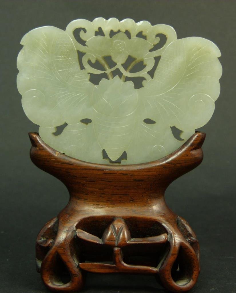 CHINSE WHITE HETIAN JADE BUDDERFLY PLAQUE: A Chinese hand carved and reticulated figural butterfly plaque set on fitted wooden base. Translucent even tone with some mottling. Measures approx. 2 3/8" height x 3 1/8" width x 3/16" depth + 1 7/8"