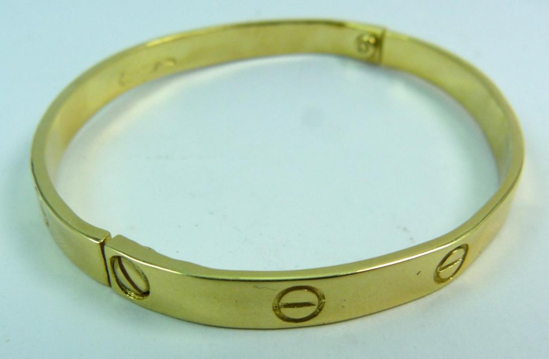 18KT YELLOW GOLD LOVE BRACELET BEARS CARTIER SIG.: 18KT YELLOW GOLD LOVE BRACELET BEARS CARTIER SIGNATURE This is 100% 18 kt yellow gold, and does have a Cartier signature , but no Cartier numbers. Has a gold weight of 15.8 DWT