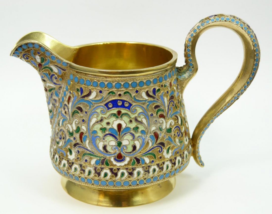 RUSSIAN ENAMEL & SILVER CREAMER: RUSSIAN ENAMEL & SILVER CREAMER Shaded blue enamel design. Measures 3" tall (7.62cm) x 5" wide (12.70cm). Bears the 84 Russian mark for silver. Possibly H.J. to base. Total weight 159g