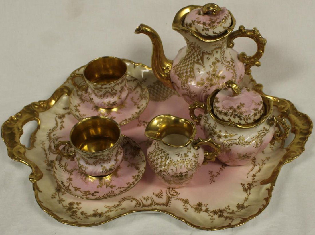 ANTIQUE LIMOGES STYE TEA FOR TWO SERVICE: Antique Limoges style tea for two service consisting of a large double handle tray, tea pot, sugar, creamer, two cups and saucers Beautifully painted in a light pink and ivory ground with antique gold
