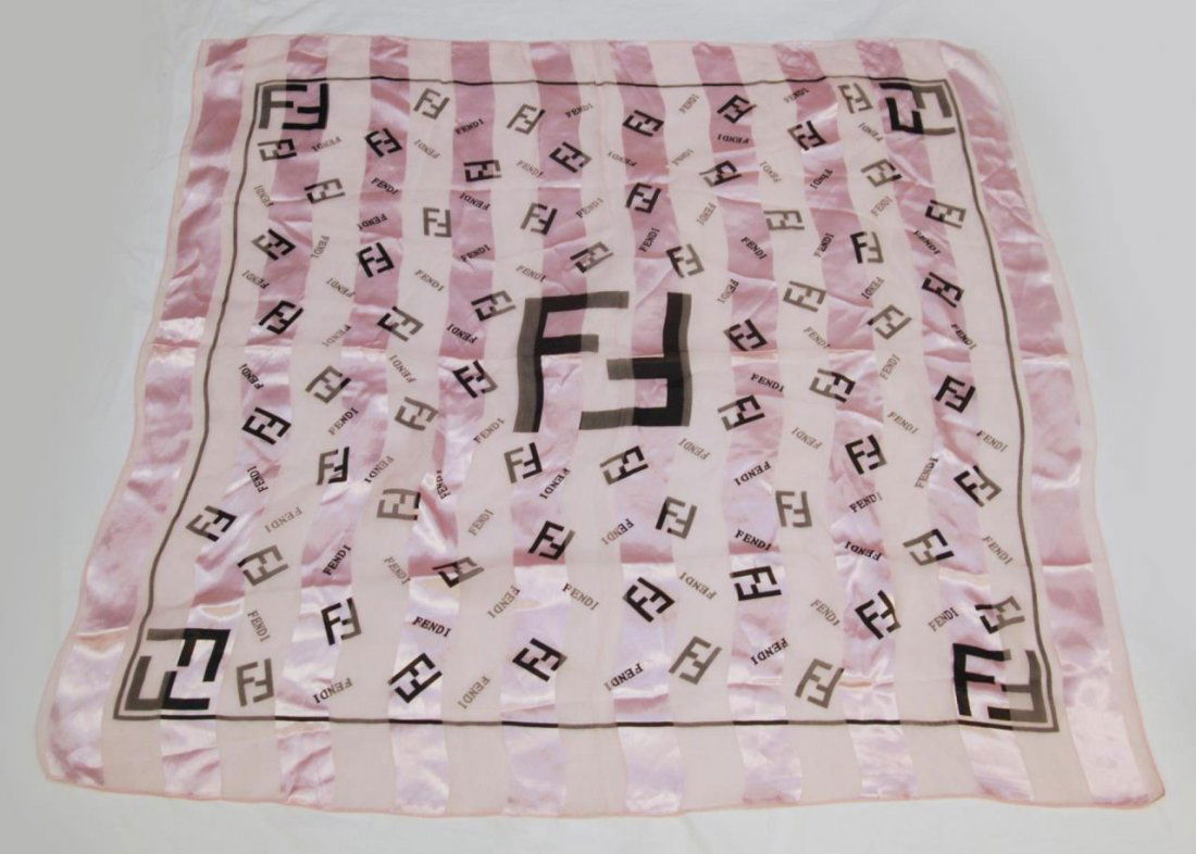 DESIGNER SILK SCARF MARKED FENDI: Designer silk scarf marked Fendi with beautiful pink silk with black lettering. Measures 40" (101.6cm) Square. Total weight 66g.