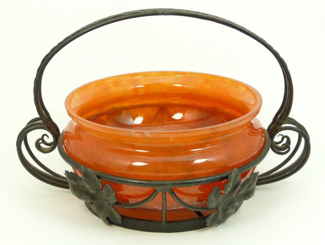 DAUM BOWL WITH MAJORELLE UNSIGNED: Bowl measures 7 3/4" (19.68cm) unsigned, but definitely French art glass. Bowl is of an orange color, and bears all the qualities of Daum. The wrought iron basket has the qualities of Majorelle. Total