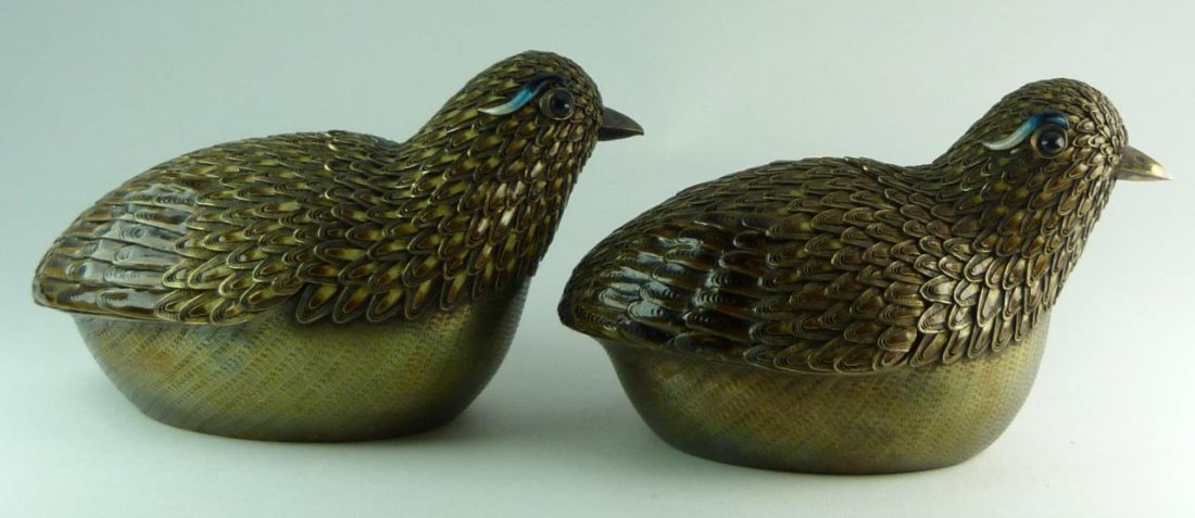 PAIR OF CHINESE SILVER & COVERED CHICK BOXES: Pair of Chinese silver and enameled chick boxes. Beautifully enameled feathers. Blue enameled eyebrows and glass eyes. Stamped silver to base. Back of chick is removable. Were purchased in China in th