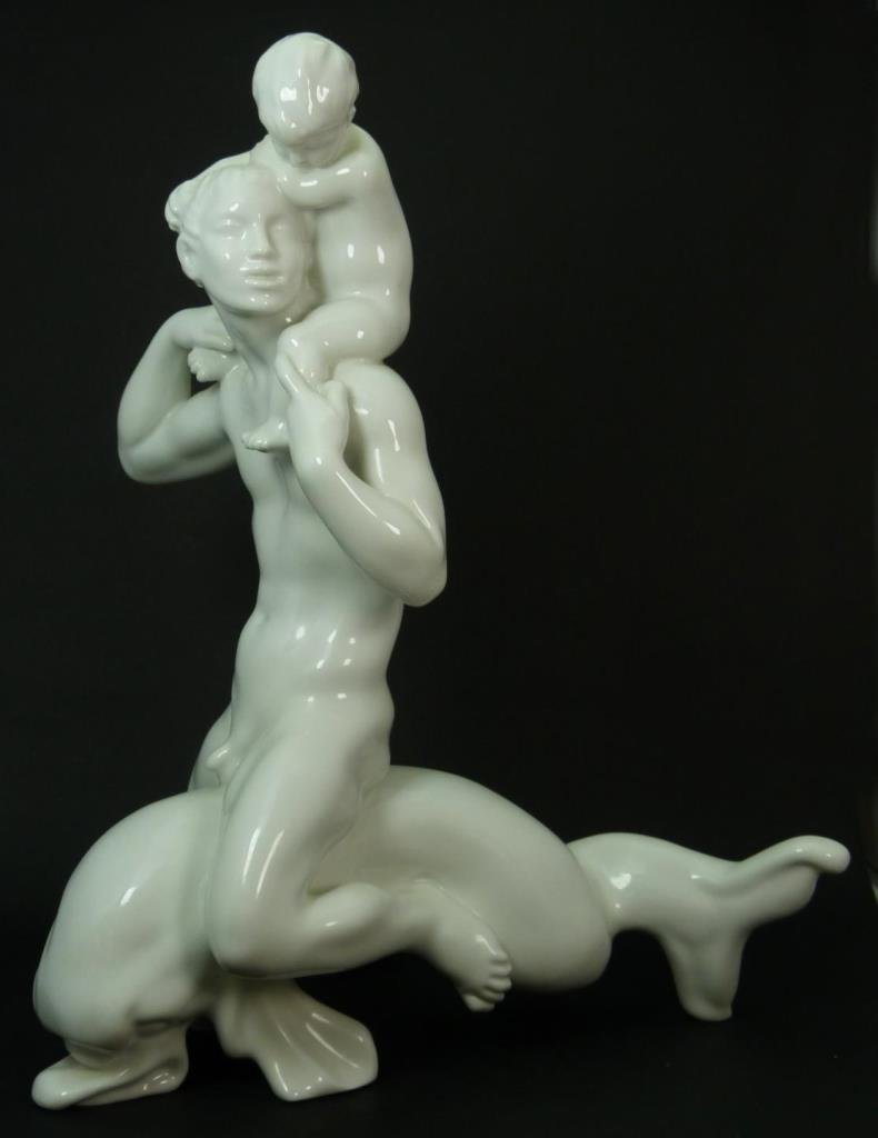 LARGE BING & GRONDAHL BLANC DE CHINE FIGURINE: Large Bing & Grondahl Blanc de Chine figurine depicting a nude male with baby on his shoulder while riding on a dolphins back. Measures approx 16 1/2" (41.91cm) Height. Total approx weight 2.9kg.