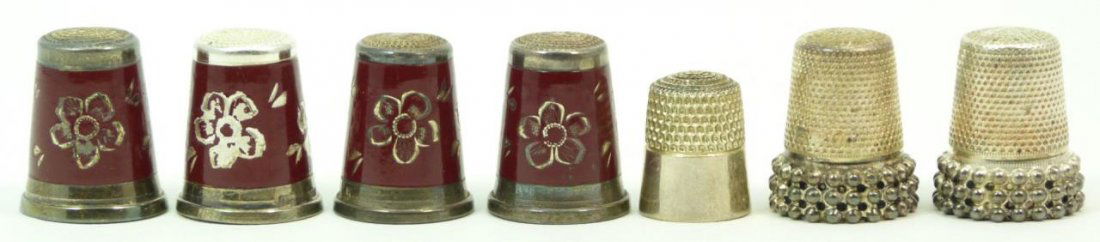LOT OF 7 ANTIQUE STERLING SILVER THIMBLES: Lot of seven German antique sterling silver thimbles. Four out of seven are enameled. Total approx weight 29g.