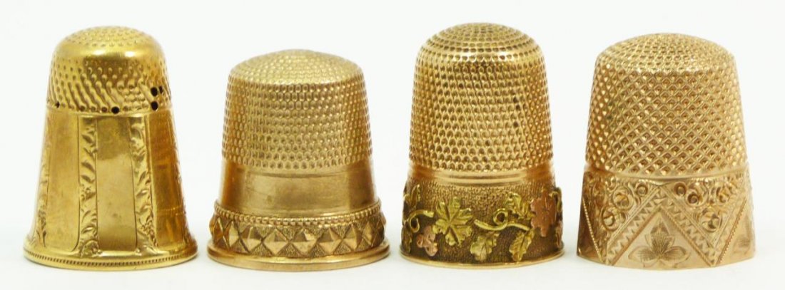 14KT YELLOW GOLD THIMBLES: Lot of four 14kt yellow gold thimbles. All knurled to top and sides. All have engraved patterns to exterior. Tallest measures 3/4" (1.91cm) Height. Total weight 12.2dwt.