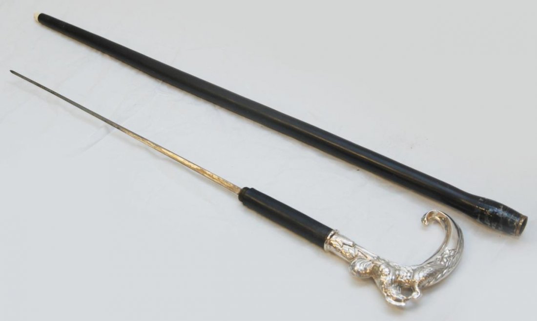 PERSONAL SILVER HANDLED WALKING CANE OF THE COUNT: Personal silver handled walking cane of of the Count Adrian Toati de Suiza de Bourbon. Handled is adorned with a rooster and a chicken and unscrews into a large dagger. Cane measures approx 36" (91.44