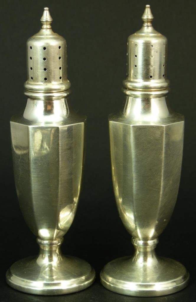 IMPRESSIVE PAIR OF ANTIQUE STERLING SILVER SHAKERS: Impressive pair of antique sterling silver shakers. Bears a shield with a horse's image marked sterling. Each measures approx 5 3/4" (14.61cm) Height. Total approx weight 4.5ozt.
