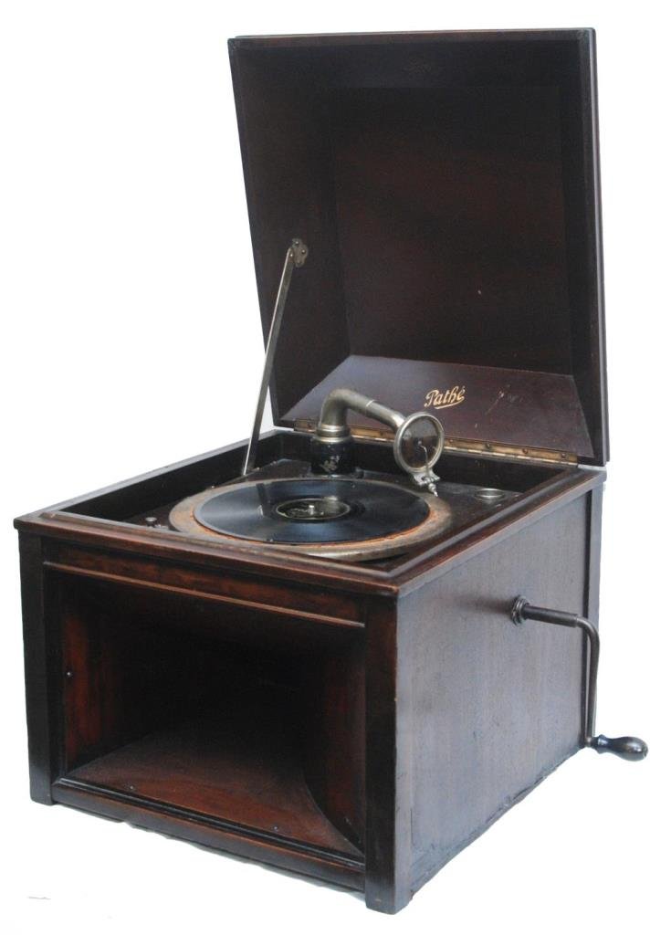 PATHE PHONOGRAPH IN WORKING CONDITION: Pathe phonograph in a wooden mahogany cabinet. Has original crank. Measures approx 19" Depth x 17" Width x 17" Height.