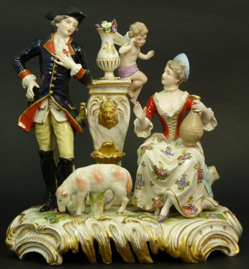 ANTIQUE GERMAN PORCELAIN GROUP BLUE CROSS SWORDS: Bears a cross sword mark to base. Features a Colonial couple with cherub. Grouping measures 9 1/2" tall (24.13cm) Total weight 1759 grams