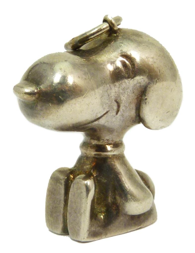 SIGNED CARTIER SNOOPY STERLING SILVER PENDANT: In the shape of Snoopy. Measures approx 3/4" (1.91cm) Length. Signed to base Cartier. Purchased at Cartier New York approximately thirty years ago. Total approx weight 28g.