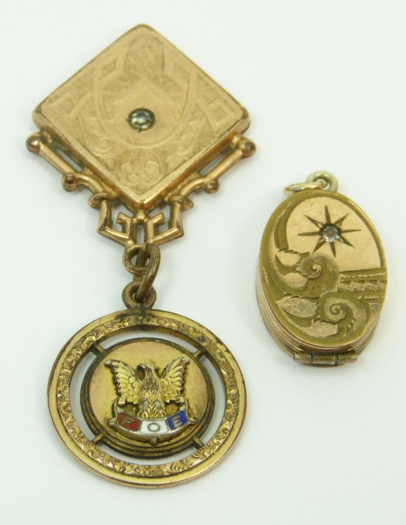 3 PIECES OF VICTORIAN 9KT ROSE GOLD CHARMS: Three pieces of Victorian 9kt rose gold charms. One being a locket with a small diamond chip. Another being a F.O.E. medal. The last one being a charm with a diamond chip. Total approx. weight 11.5dwt