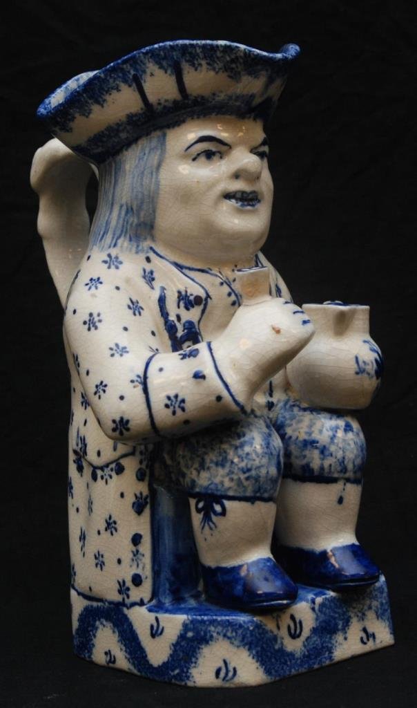 ANTIQUE STAFFORDSHIRE BLUE & WHITE COLONIAL TOBY: Depicting a colonial soldier drinking libations. Unsigned. Last quarter of the 19th century. Measures 10" (25.4cm) Tall. Total weight 1.44kg.