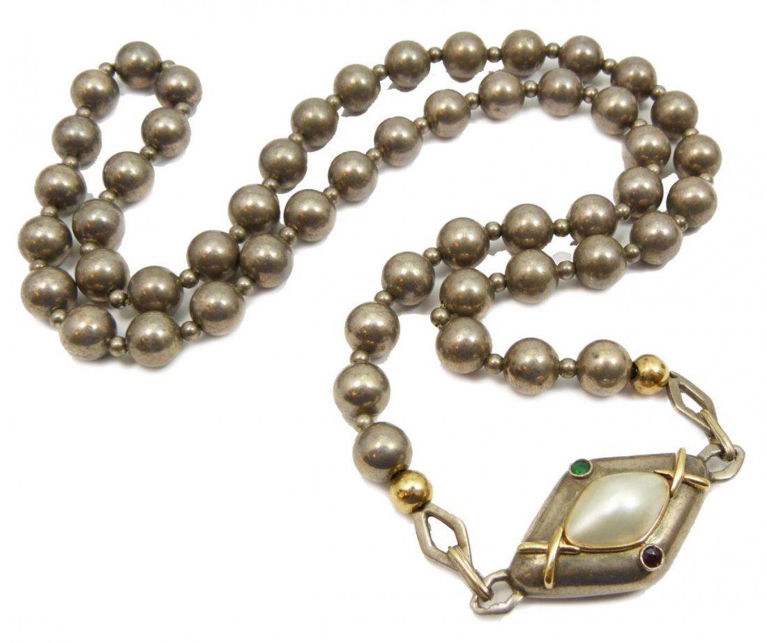 14KT YG & STERLNG NATIVE AMERICAN SIGNED NECKLACE: Sterling silver beaded necklace with gold accent beads. Pendant has an emerald, a ruby and mabe pearl accented with 14kt yellow gold. Signed L.B. for Les Baker. Circa 1950s. Measures approx 30" (76.2c