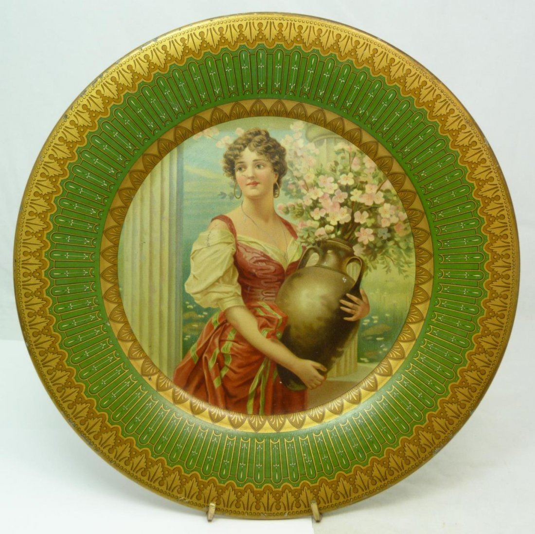 ANTIQUE CHARLES SHONK METAL PORTRAIT PLATE: Charles A. Shonk Royal Saxony Vienna style metal portrait plate depictng girl with amphora vase. Red maker's marks to verso. Measures approx. 10 1/4" diameter (26cm). Total weight approx. 294 grams.