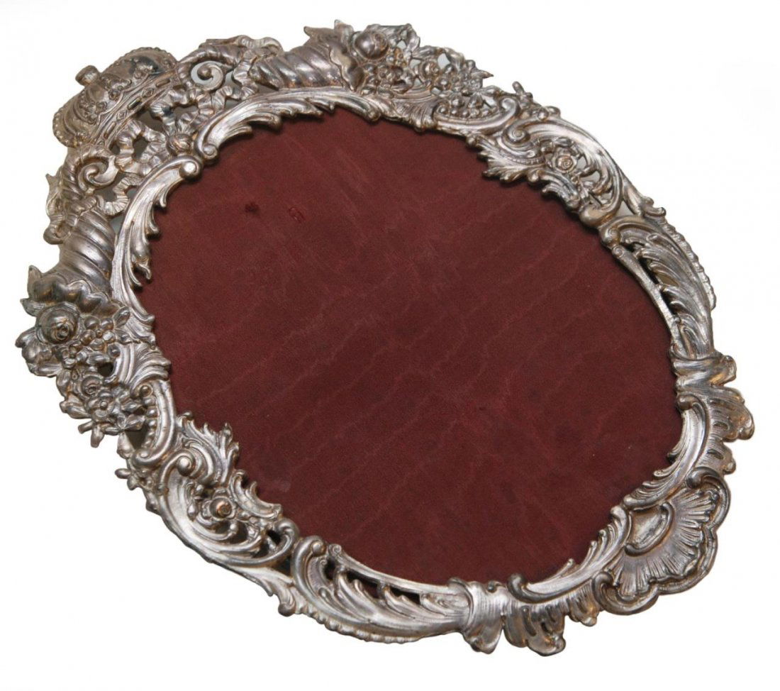 ANTIQUE CONTINENTAL SILVERPLATE FLORAL CROWN FRAME: Antique Continental silver plate picture frame having a scrolled floral design throughout with crown to top. Impressed 'd G Maltese Cross' marks. Probably English. Measures approx. 12 1/4" length (31.