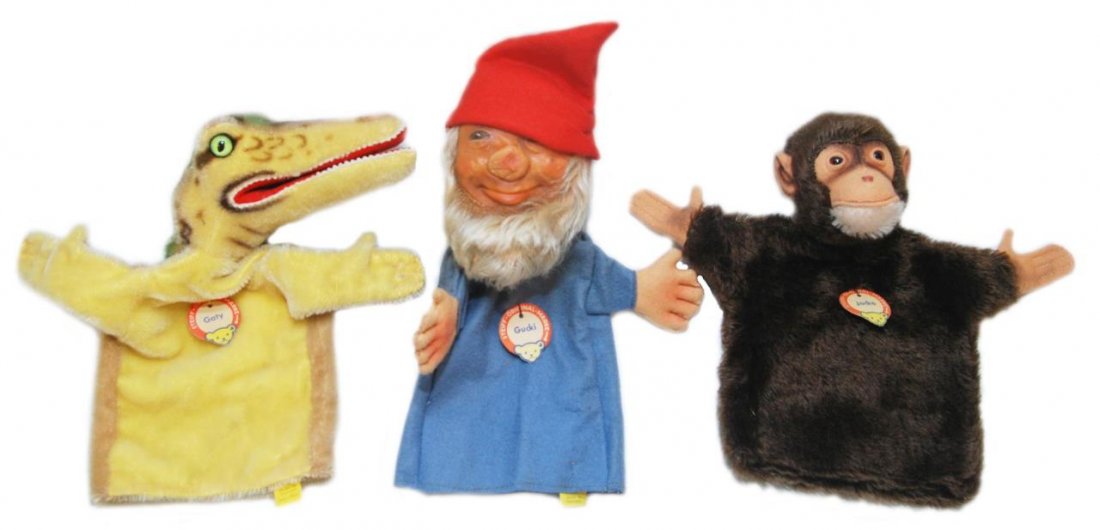 THREE STEIFF PUPPETS GATY, GUCKI & JOCKO: To include Gaty the alligator, Gucki the gnome and Jocko the monkey. Each measures approx 9" (22.86cm) Length. Total collective weight 200g. Each has the ribbon and button to the ear.