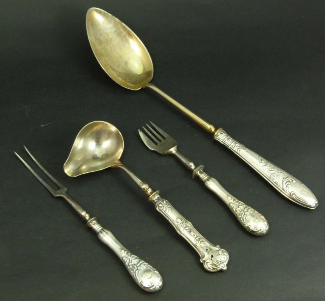 FOUR ANTIQUE RUSSIAN STERLING HANDLE UTENSILS: To include a large stuffing spoon, a gravy ladle and two serving forks. Each are marked 918 and 84 for Russian silver. Total collective weight 258g.