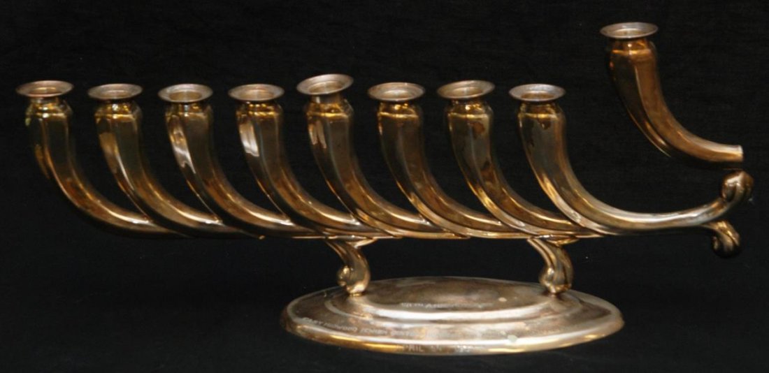 HAZORFEM STERLING SILVER MODERNE MENORAH: Has all eight candleholders and larger Shamas. Menorah is from a prominent Boca Raton estate. Measures 15"(38.1cm) Long. Total approx weight 17ozt.