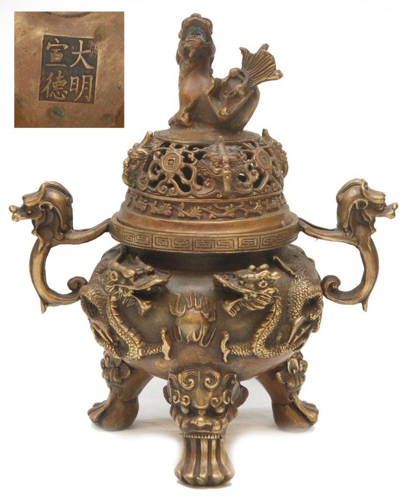 ANTIQUE XUANDE MARK CHINESE GILT BRONZE CENSER: Antique Chinese heavy gilt bronze dragons tripod censer urn. Figural foo lion finial to reticulated cover depicting foo masks. Impressed four character calligraphy Ming Xuande reign mark, but probably