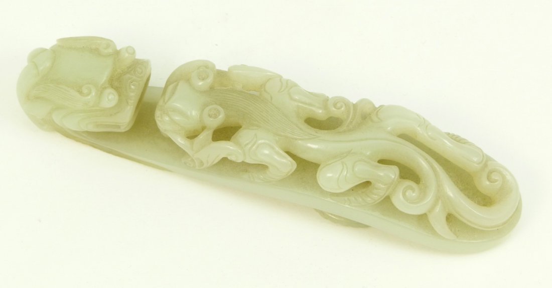 CHINESE QING PERIOD WHITE HETIAN JADE GARMENT HOOK: Antique early Qing Dynasty Period Chinese hand carved white He Tian jade figural Ruyi scepter garment hook having raised and reticulated figural Chih Lung dragons design. Carved Yin-Yang symbol to ver