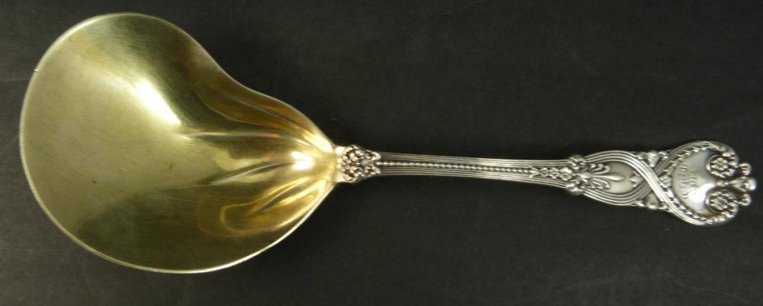 TIFFANY STERLING 'ST. JAMES' BERRY SERVING SPOON: Tiffany & Company sterling silver Berry / Casserole serving spoon with kidney shaped bowl. Gold wash bowl. Marked 'TIFFANY&CO. STERLING PAT.1X9X.T' to verso of neck. Measures approx. 9 1/2" length (24