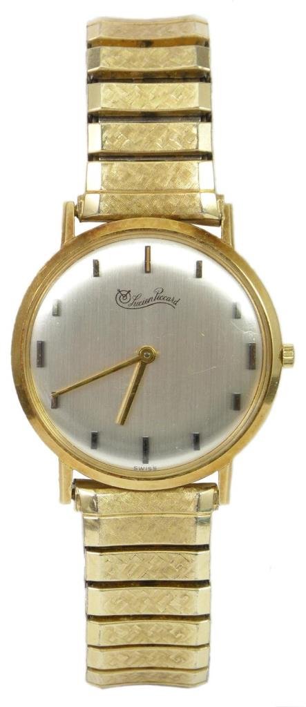 LUCIEN PICCARD VINTAGE GENTS 14K YG WRIST WATCH: A 14k yellow gold Lucien Piccard gents wrist watch having a silver tone face with applique gold tone notches. Gold hour and minute hands. Veso of case marked 'LUCIEN PICCARD 14K SWITZERLAND -PATENT PE