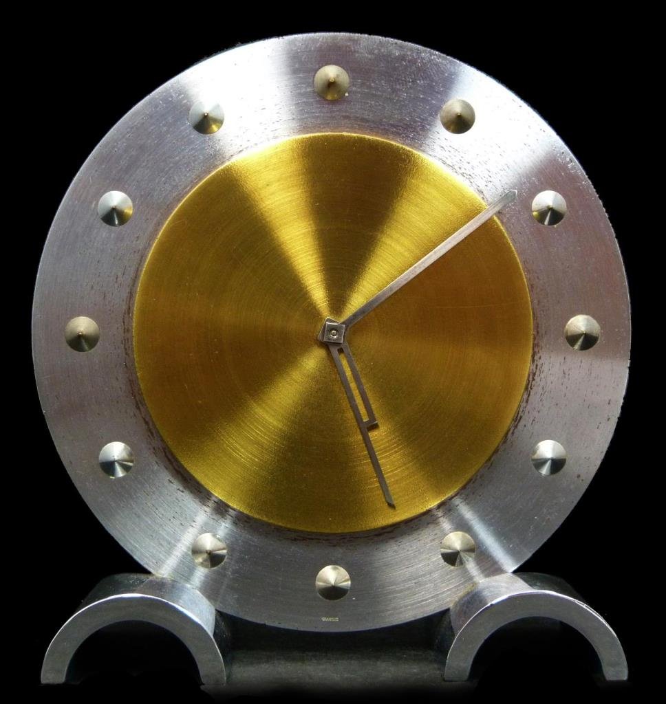 MOVADO STAINLESS STEEL TABLE CLOCK: Movado stainless steel table clock. Measures 5" diameter(13.2cm diameter). Total weight 855g