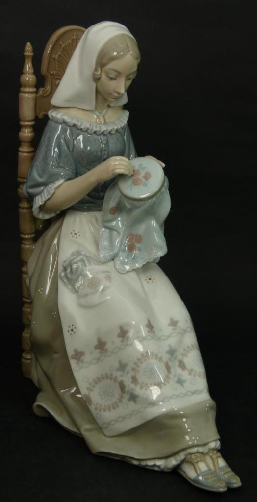 RETIRED LLADRO "EMBROIDERE" #4865 STATUE: Lladro figurine #4865 "Embroiderer" depicting woman seated in high-back chair with needlepoint. Lladro mark to bottom. Retired 1994. Measures 11" tall by 5" wide(27.94cm tall by 12.7cm wide)