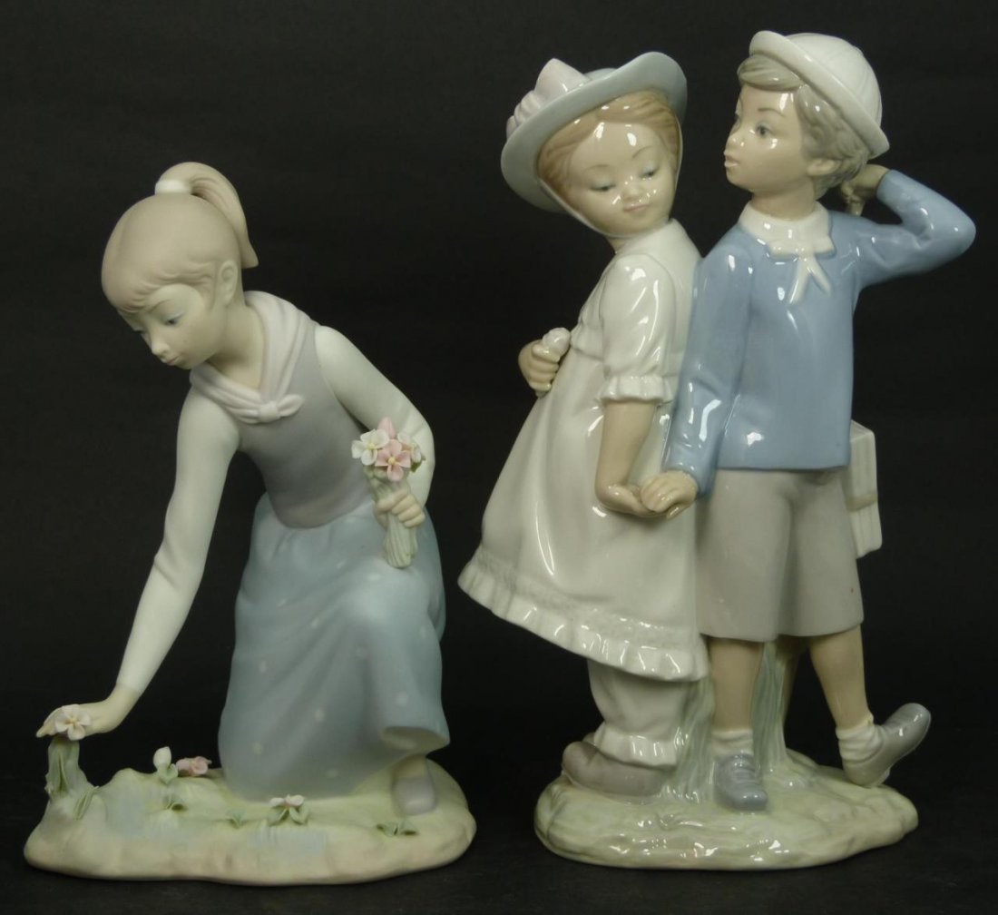 (2) LLADRO PORCELAIN STATUES: (2) Lladro porcelain statues. Boy and girl "puppy love" #1127. Measures 10" tall by 6" wide(25.4cm tall by 15.24cm wide), Bisque finish girl picking flowers #1172, Measures 9" tall by 6" wide (22.86cm