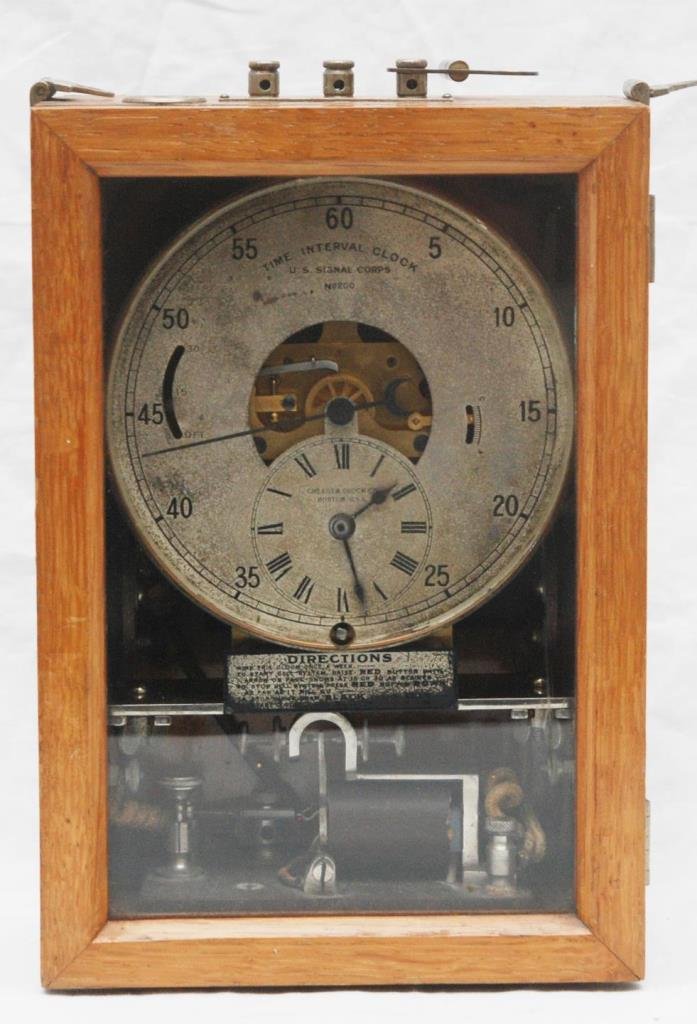 U.S. SIGNAL CORPS TIME INTERVAL CLOCK No200: United States Signal Corps Military 'Time Interval Clock' Number 200 by Chelsea. Has wooden case with glass screen front. Hinged shoulder strap brackets to corners. Top with Battery, common and line w