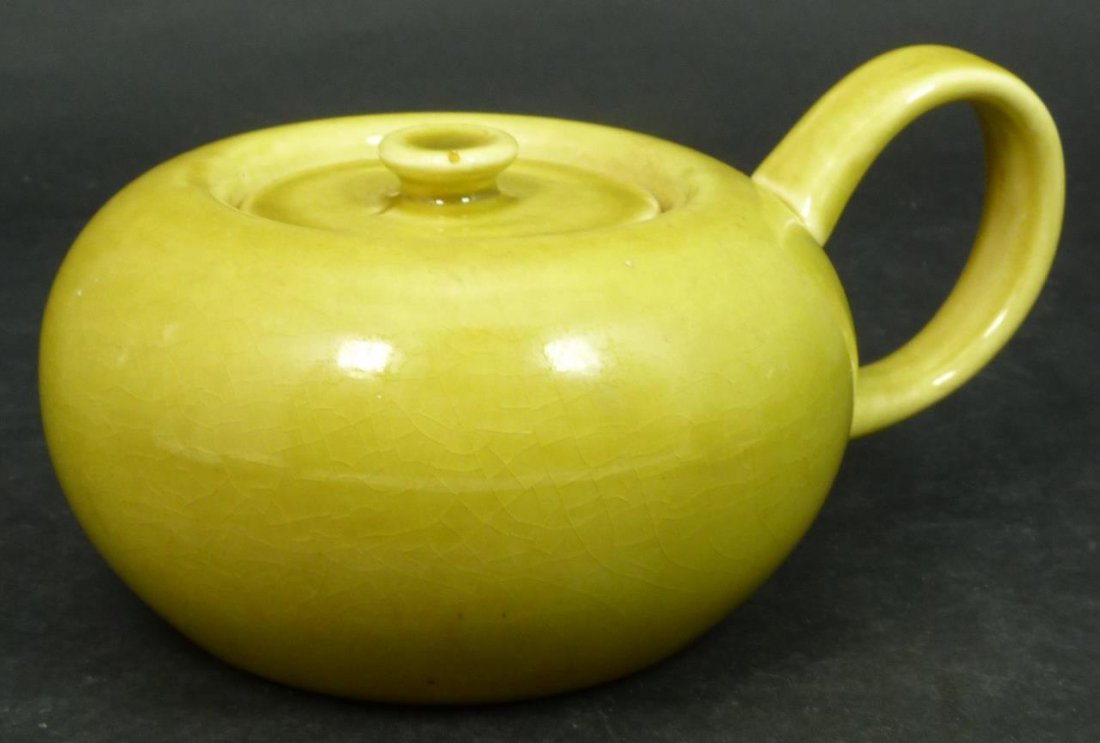 RUSSEL WRIGHT POTTERY CHARTRUESE COVERED SUGAR: Russel Wright American industrial chartreuse glazed pottery handled and covered sugar bowl. Measures approx. 3" height x 6" length x 4 1/2" width (7.6cm x 15cm x 11.4cm). Total weight approx. 358 gram