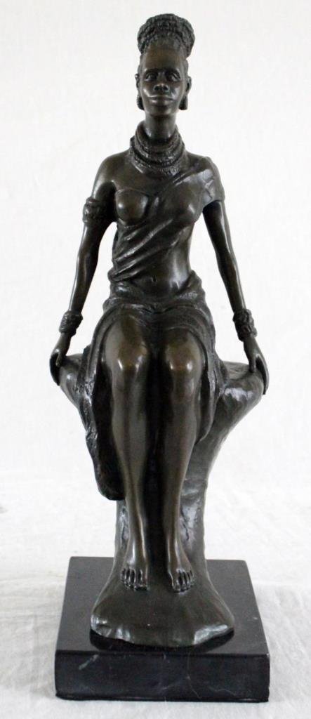 1909 PARIS BRONZE SCULPTURE OF AFRICAN WOMAN: Antique Paris bronze sculpture depciting a seated African woman. Impressed ''EP C/F PARIS 1909' foundry mark. Mounted on black marble base. Measures approx. 14 3/4" height + 1 1/4" (40cm + 3.2cm). Tot