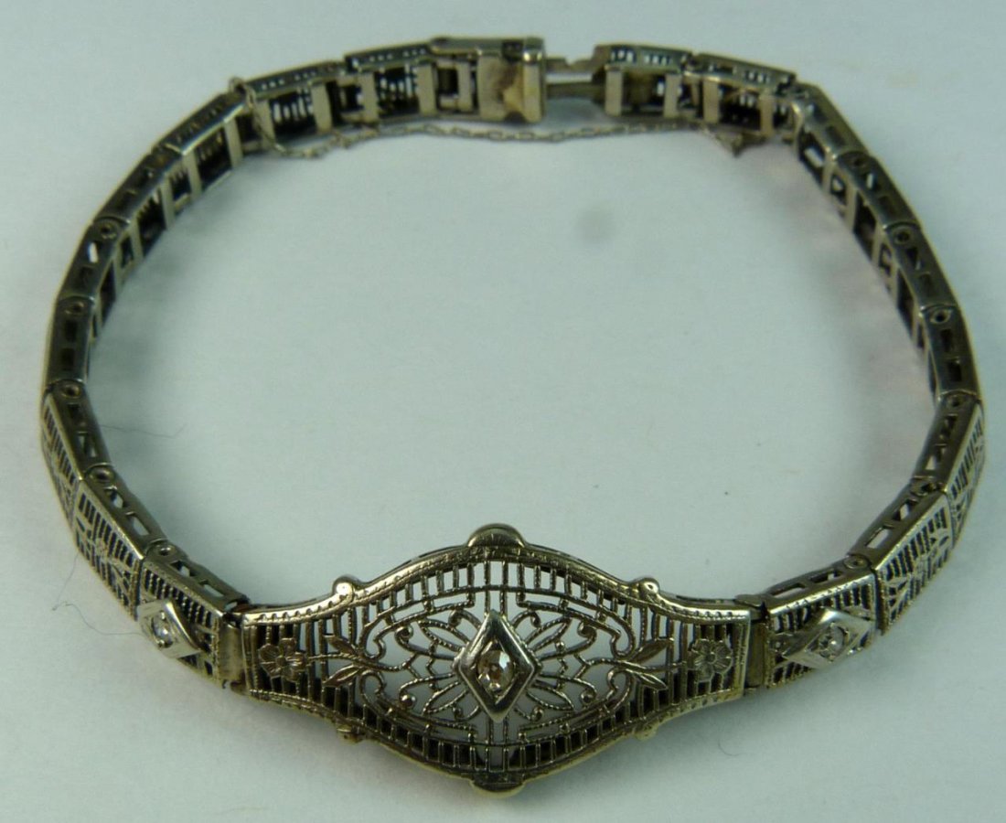 10K WHITE GOLD ART DECO BRACELET: Old 10k white gold Art Deco bracelet set with 3 round cut white gemstones. Has safety catch chain. Measures approx. 6 1/2" length (17cm). Total weight approx. 4.3dwt.