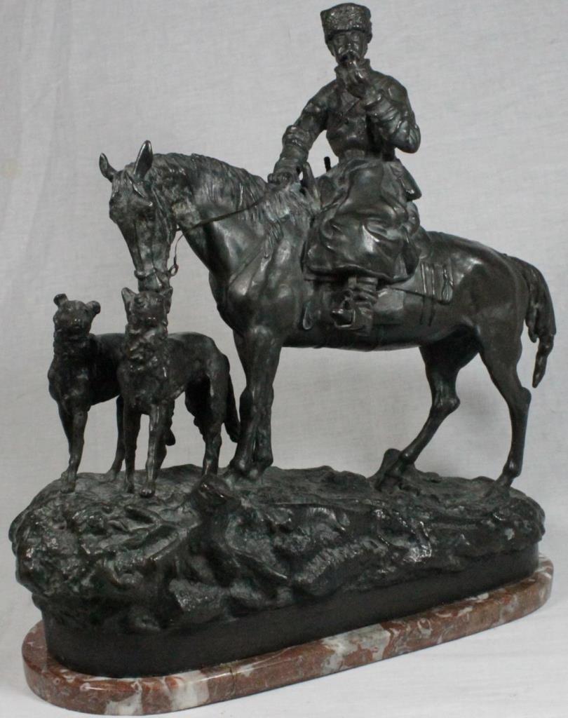 AFTER GRACHEV RUSSIAN BRONZE EQUESTRIAN GROUP: Bronze equestrian group sculpture after Vassili Yacovlevitch Grachev (RUSSIAN, 1831 - 1905). Depicts a Cossack hunter smoking a pipe on horseback with two Borzoi dogs. Signed in Cyrillic to bronze bas
