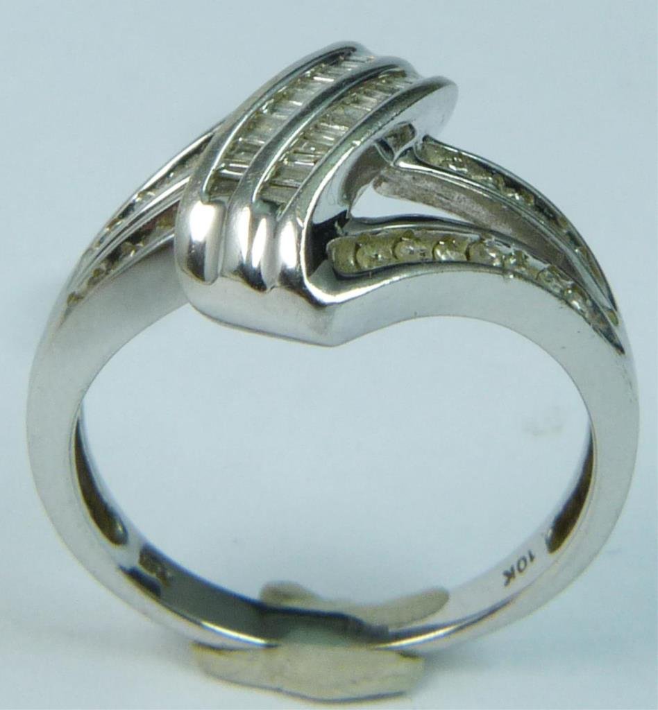 LADIES 10K WHITE GOLD DIAMOND RING: Ladies 10K white gold ring featuring numerous round and baguette cut diamonds. Impressed '10K' to inside of band. Ring size approx. 7. Total weight approx. 2.4 kilograms.