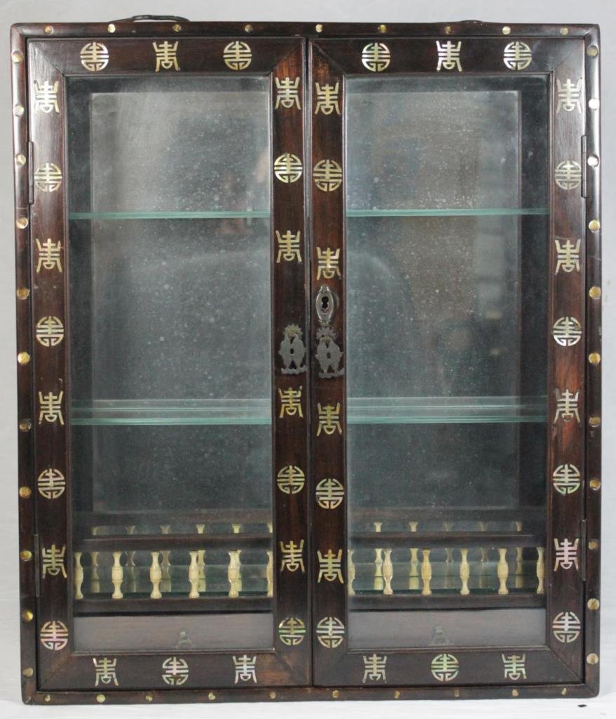 VINTAGE CHINESE WOODEN INLAID NETSUKE CABINET: Vintage Chinese carved wooden inlaid netsuke cabinet having an inlaid design depicting symbols throughout. Bronze hardware. Locking mechanism to front (we do not have the key). Measures approx. 19 1/4
