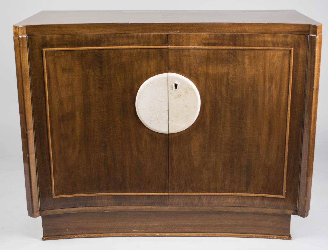 Art Deco Cabinet: Rectangular top with a concave front over a conforming two door cabinet with parchment medallion decoration, on a conforming plinth base. Height 36 inches, width 45 inches, depth 21 inches. Notice to