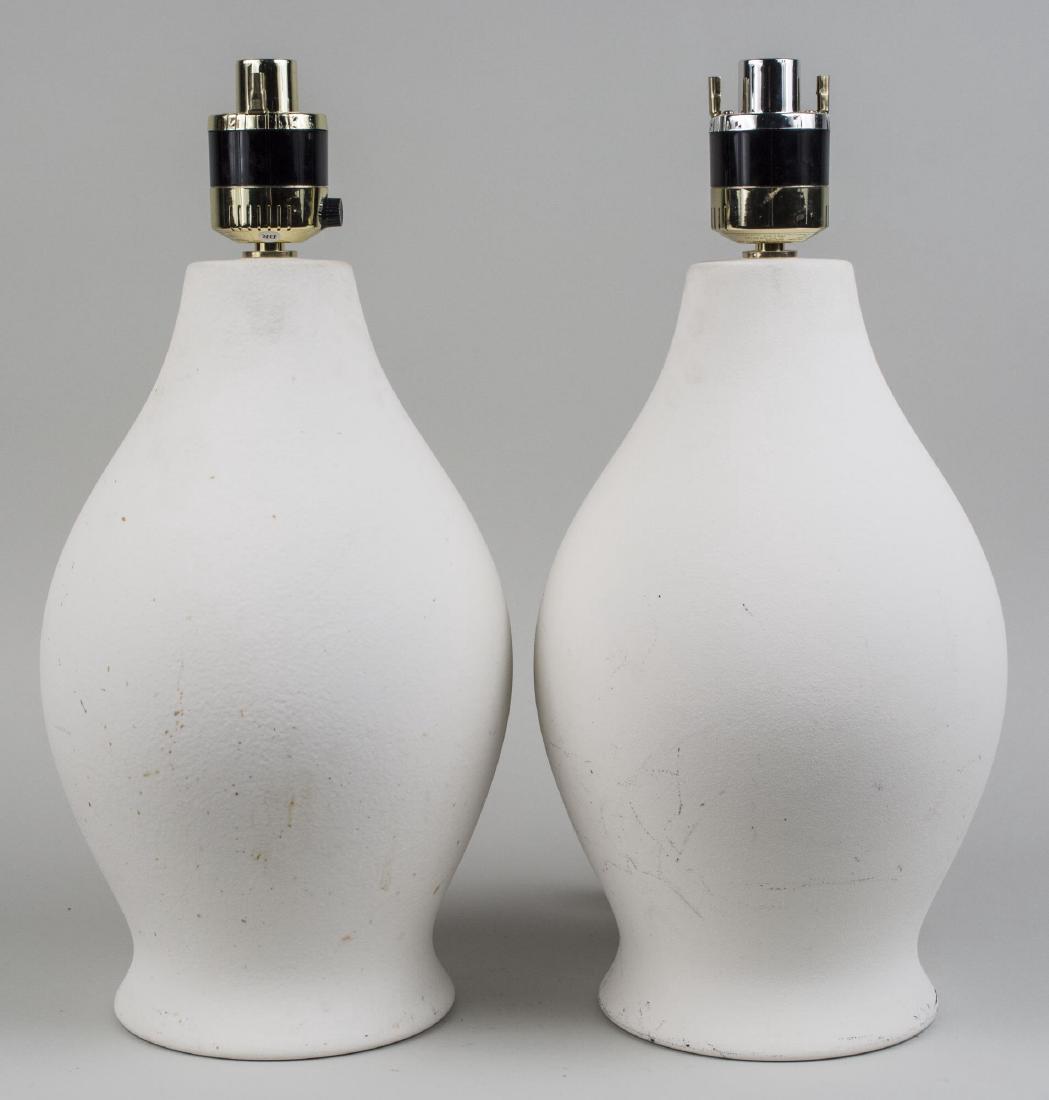 Pair of Ceramic Lamps: White unglazed lamps, each a single light lamp, with ovoid form body with spread foot. Overall height 21 inches. Notice to bidders: Condition reports and additional photographs are provided by request