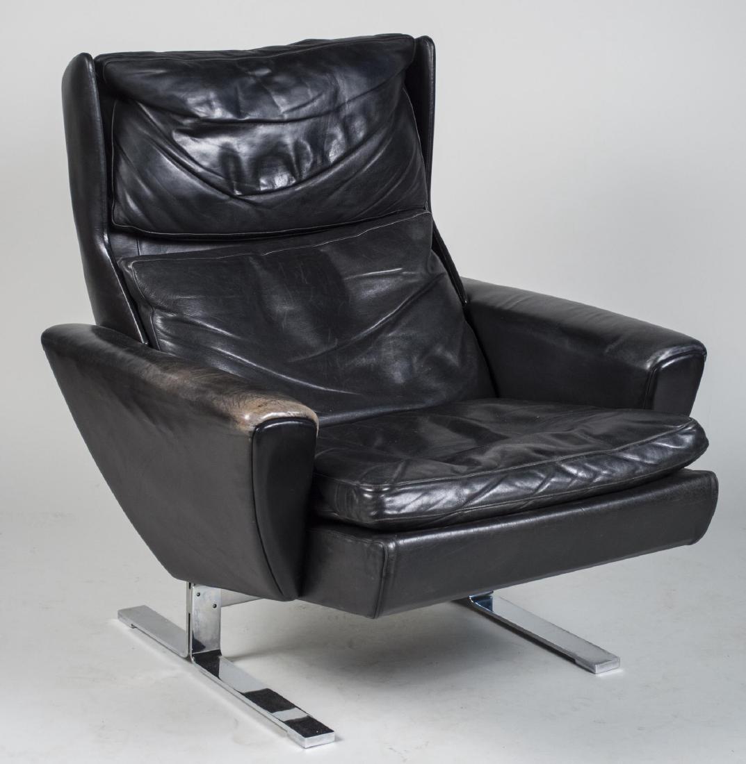 Borge Morgensen Model 2431 Leather Armchair: Made by Fredericia Stolefabrik, with label, black leather upholstery, on a chrome trestle base. Height 36 inches, width 32 inches, depth 36 inches. Notice to bidders: Condition reports and additional