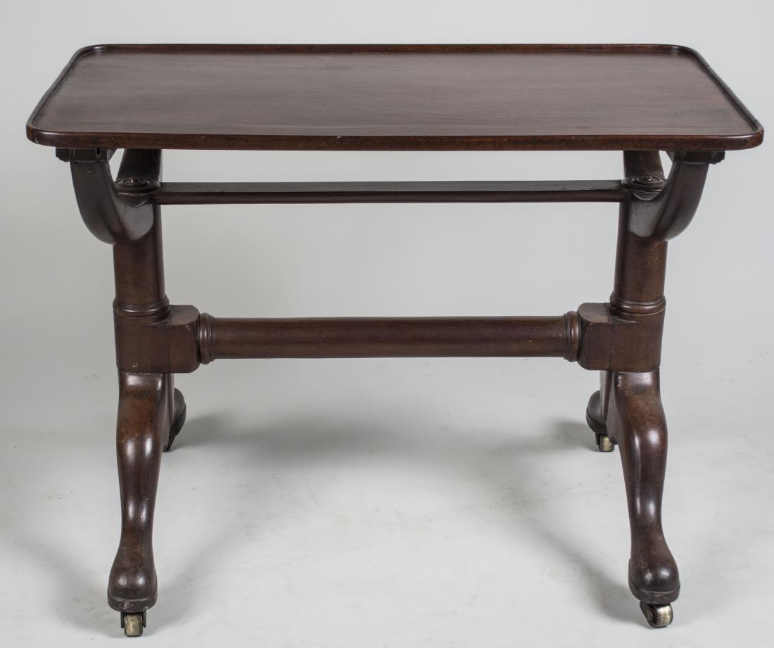 Walnut Trestle Base Table: Rectangular dish top on a trestle base. Height 26 inches, width 36 inches, depth 20 inches. Notice to bidders: Condition reports and additional photographs are provided by request as a courtesy to our