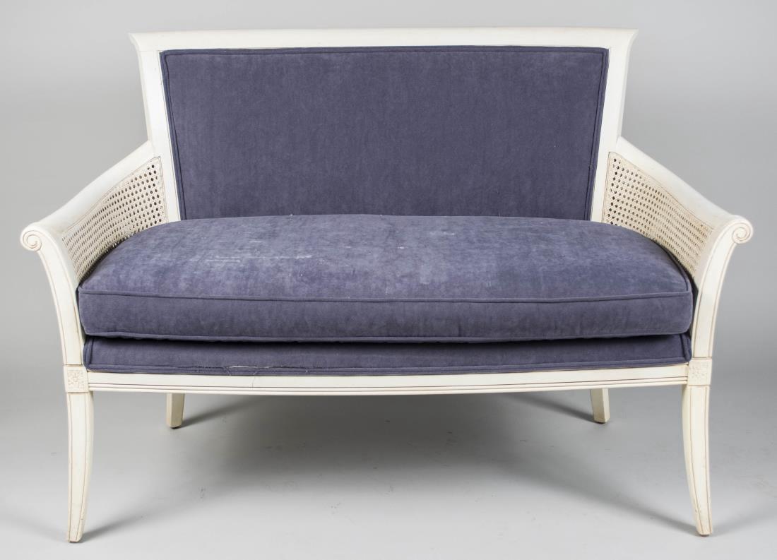 Ethan Allen White Painted Settee: Rectangular upholstered back on outscrolled arms with caned side panels, cushion seat, slightly splayed legs. Height 37 inches, width 53 1/2 inches, depth 30 inches. Notice to bidders: Condition repor