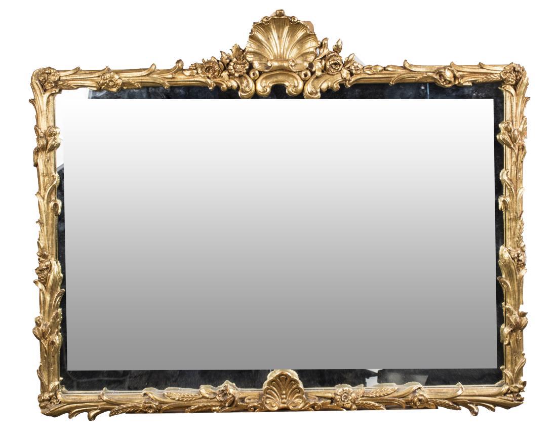 Rococo Style Gilt Wood Mirror: Rectangular plate, with shell pediment, floral and leaf decoration. 28 1/2 x 34 inches. Notice to bidders: Condition reports and additional photographs are provided by request as a courtesy to our cli