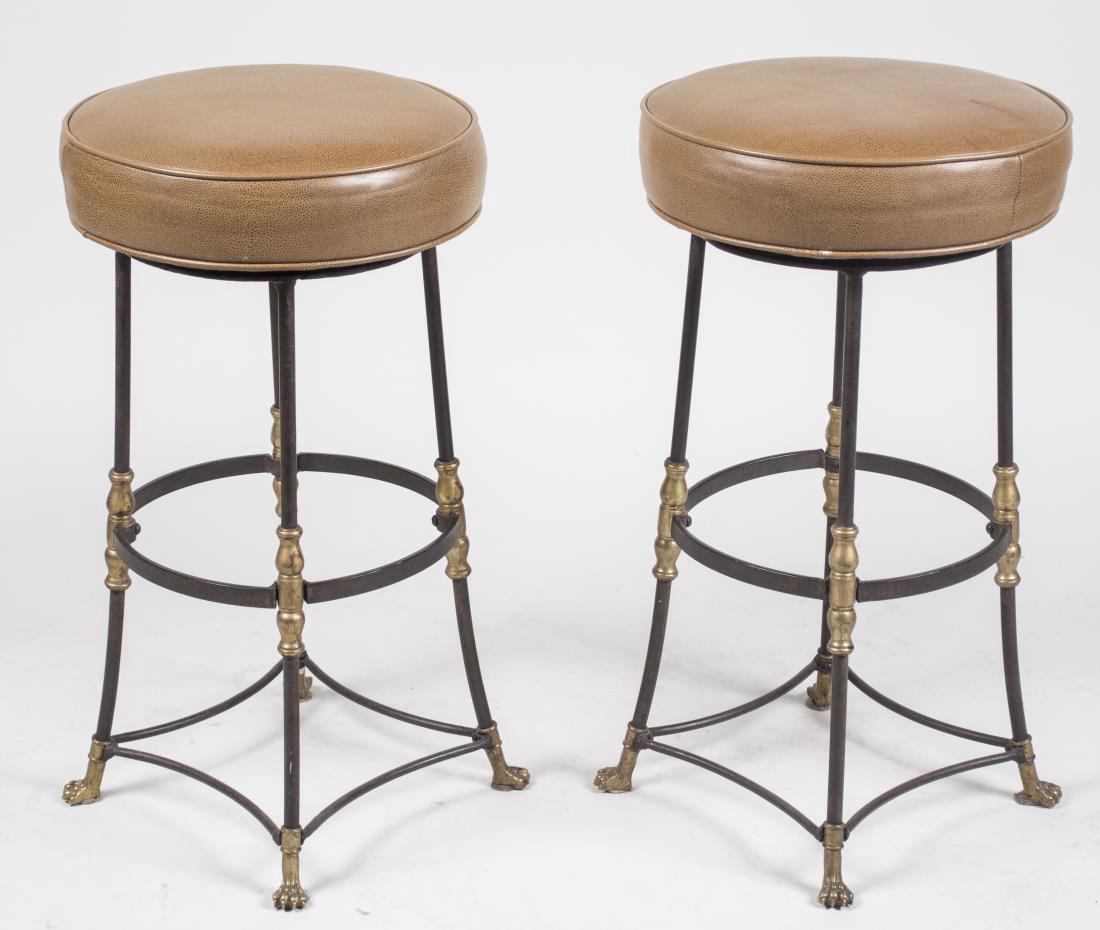 Pair of Bar Stools: Brown leather upholstered circular seats on tubular legs with brass accents. Height 28 inches, diameter 15 inches. Notice to bidders: Condition reports and additional photographs are provided by reque