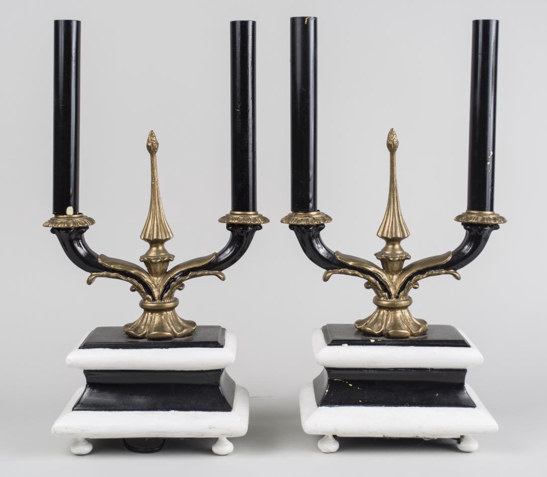 Pair of Table Lamps: Each a two light lamp in the form of a candelabra on a stepped rectangular base. Height 20 inches. Notice to bidders: Condition reports and additional photographs are provided by request as a courtesy