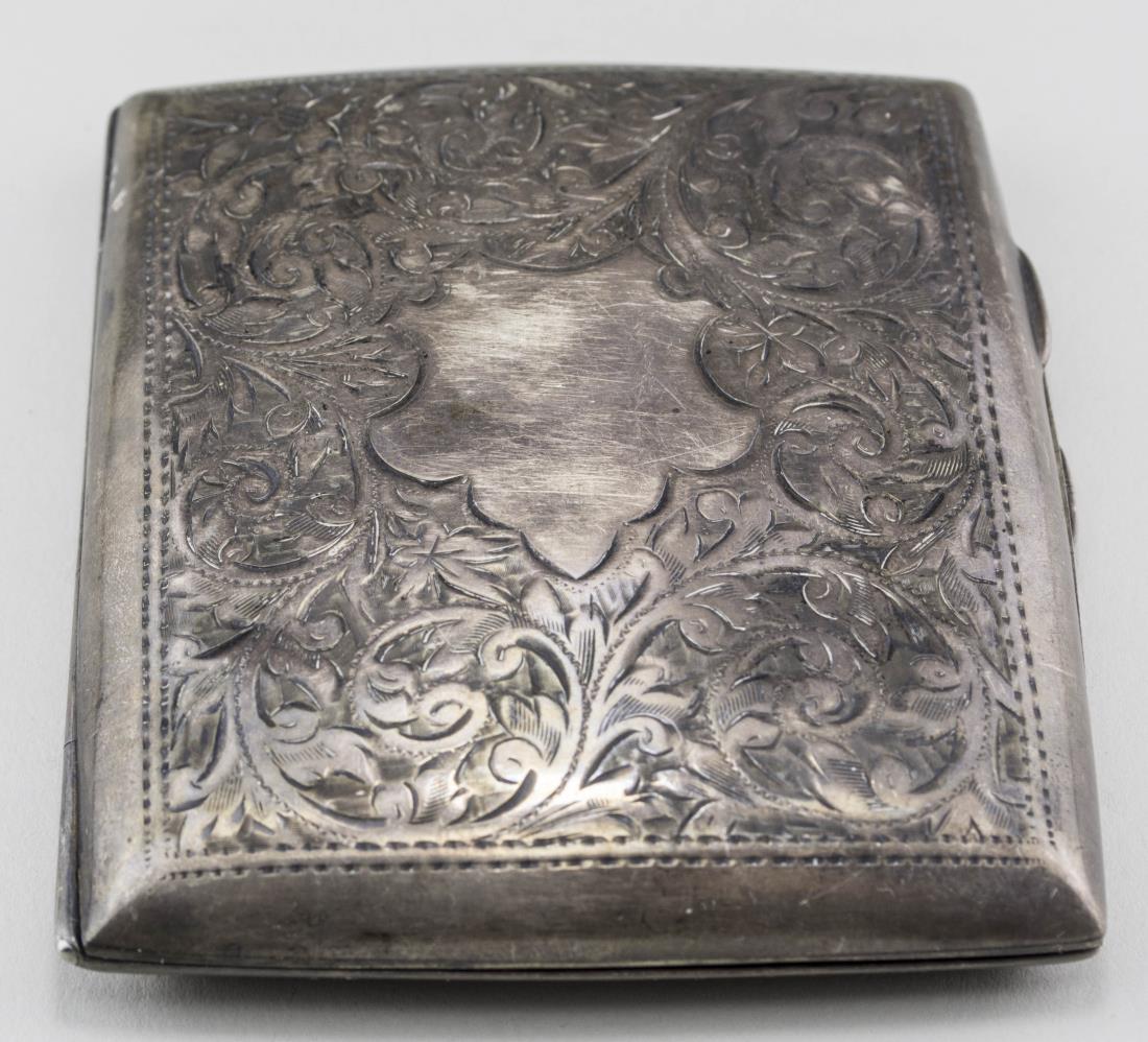 English Silver Cigarette Case: Birmingham, 1904, maker's mark S.M.L., scroll decoration with gilt interior. 3 3/8 x 2 7/8 inches, 74 grams. Notice to bidders: Condition reports and additional photographs are provided by request as 