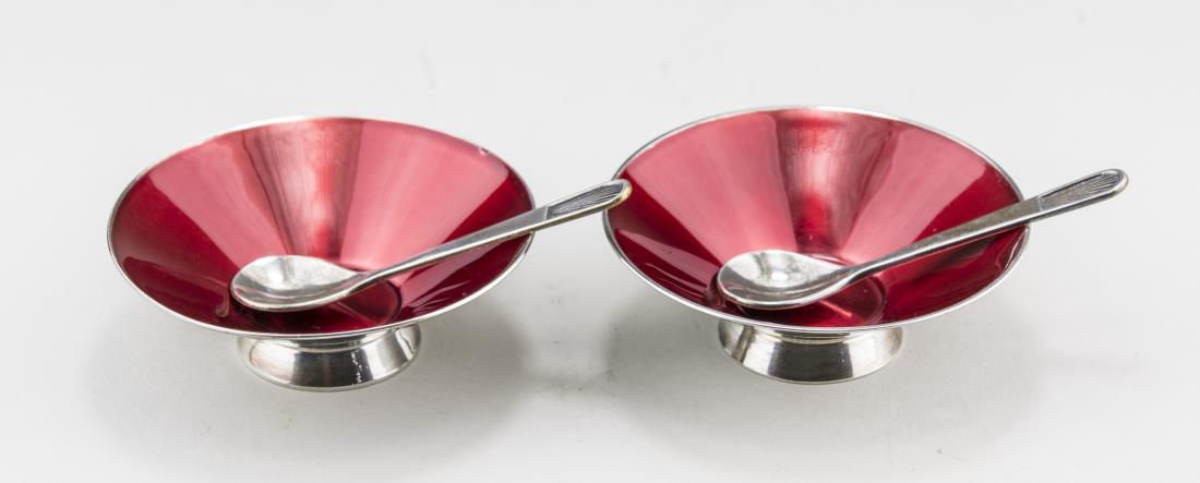 Pair of Scandinavian Enamel Salt Cellars & Spoons: Red enamel salt cellars with spoons. Diameter 2 1/2 inches. Notice to bidders: Condition reports and additional photographs are provided by request as a courtesy to our clients, as such any condition 