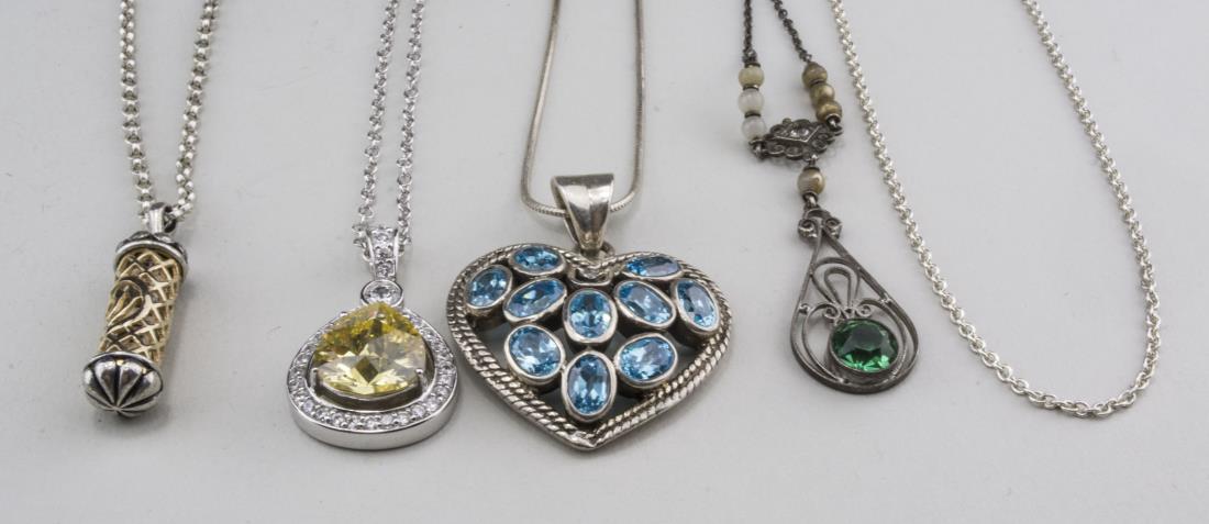 Group of Sterling Silver Pendant Necklaces: Including one with heart shaped pendant with blue stones, a Tiffany & Co, sterling silver chain only, pendant with simulated yellow diamond, etc. Notice to bidders: Condition reports and additional ph